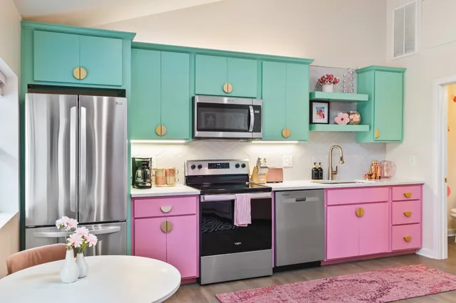 a kitchen with stainless steel appliances granite countertop a refrigerator a stove and a microwave