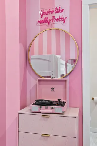 a living room with furniture a flat screen tv and kitchen view