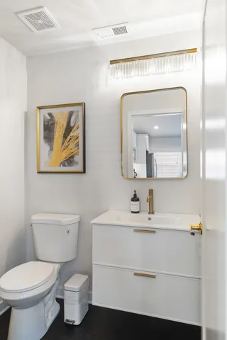 a kitchen with stainless steel appliances granite countertop a sink a stove and a refrigerator