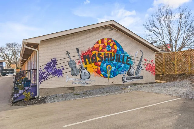 a bedroom with two beds and a large window
