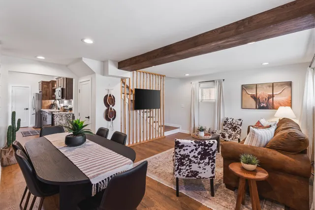 a living room with furniture a rug and a window