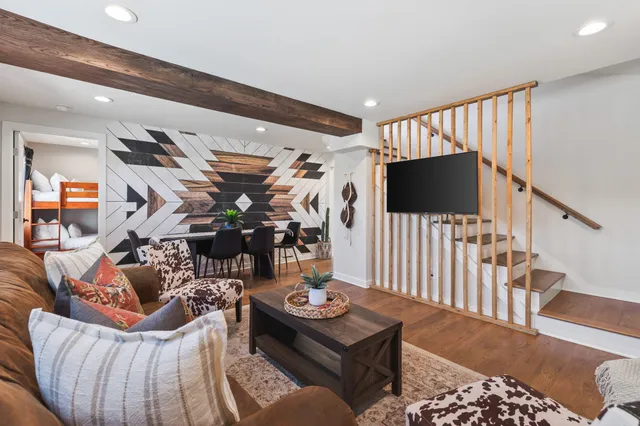 a bedroom with a bed and a painting on the wall