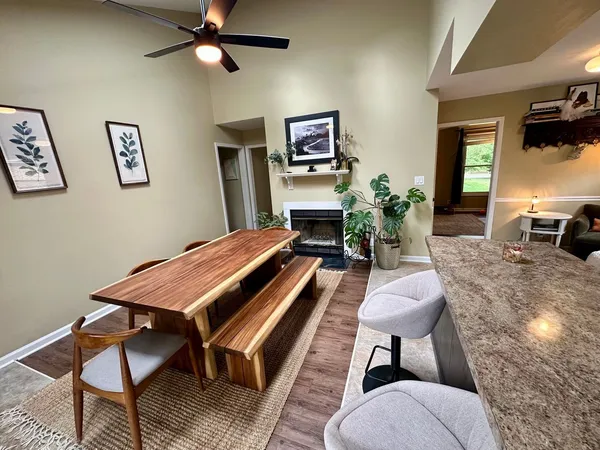 a living room with furniture a flat screen tv and a potted plant