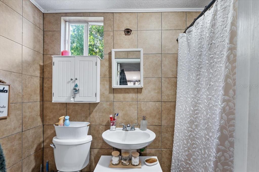 812 West Bryan Street Kissimmee, FL 34741 - Photo 12 of 27 a bathroom with a toilet sink and mirror