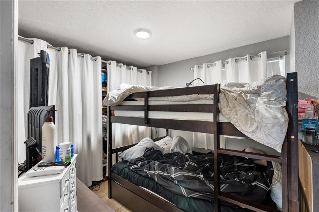 812 West Bryan Street Kissimmee, FL 34741 - Photo 13 of 27 a view of walk in closet with clothes and shoes