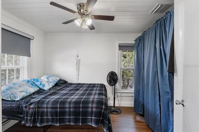 a bedroom with a bed and a window