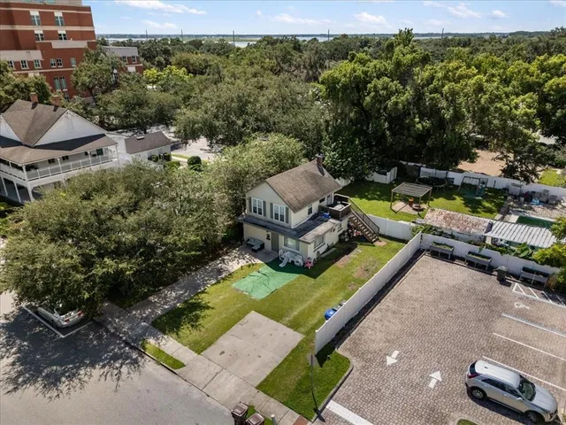 an aerial view of a house with backyard swimming pool and outdoor seating
