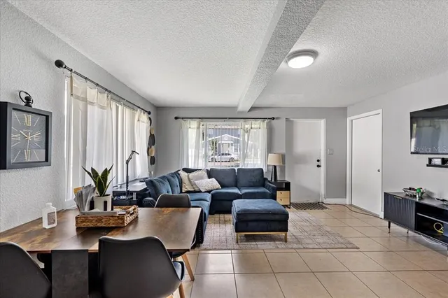 a living room with furniture and large windows