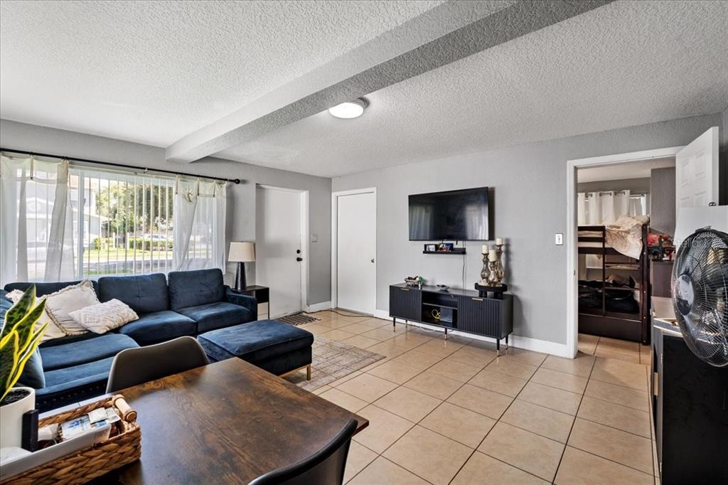 812 West Bryan Street Kissimmee, FL 34741 - Photo 9 of 27 a living room with furniture and a flat screen tv