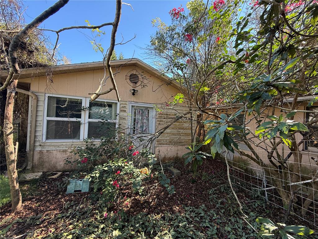 6515 Taylor Court New Port Richey, FL 34653 - Photo 2 of 23 a view of a house with a yard and garden