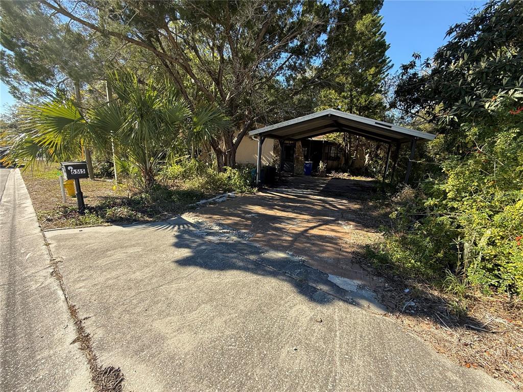 6515 Taylor Court New Port Richey, FL 34653 - Photo 3 of 23 a yellow house with trees in front of it