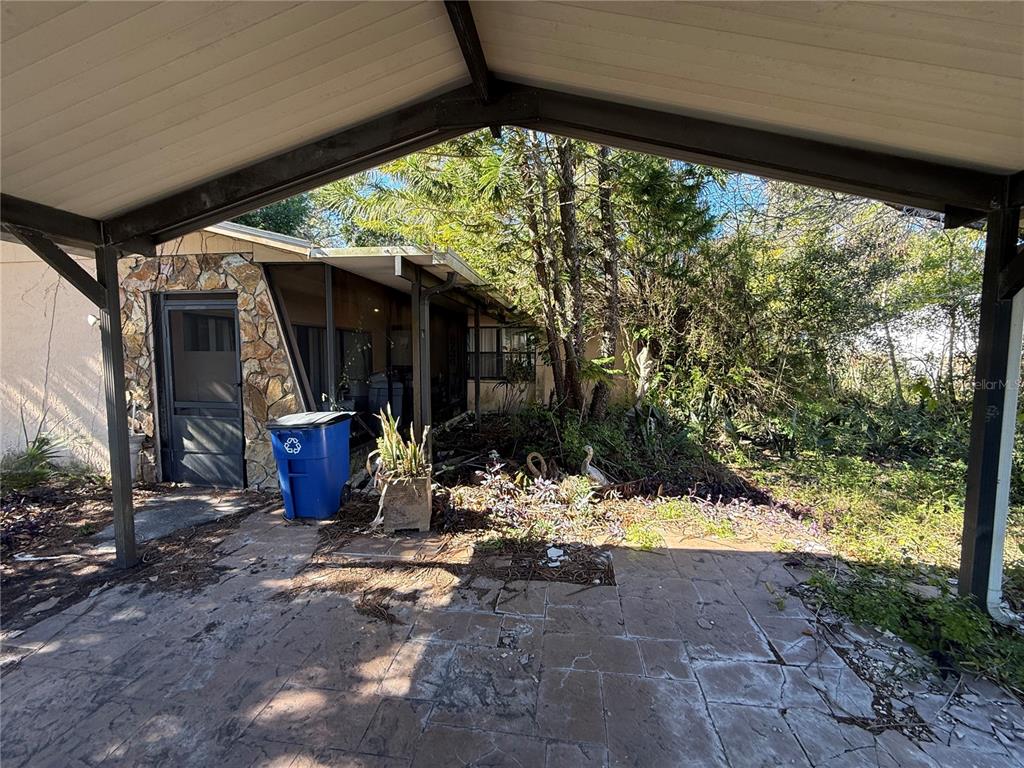 6515 Taylor Court New Port Richey, FL 34653 - Photo 7 of 23 a view of a porch with chairs and a yard