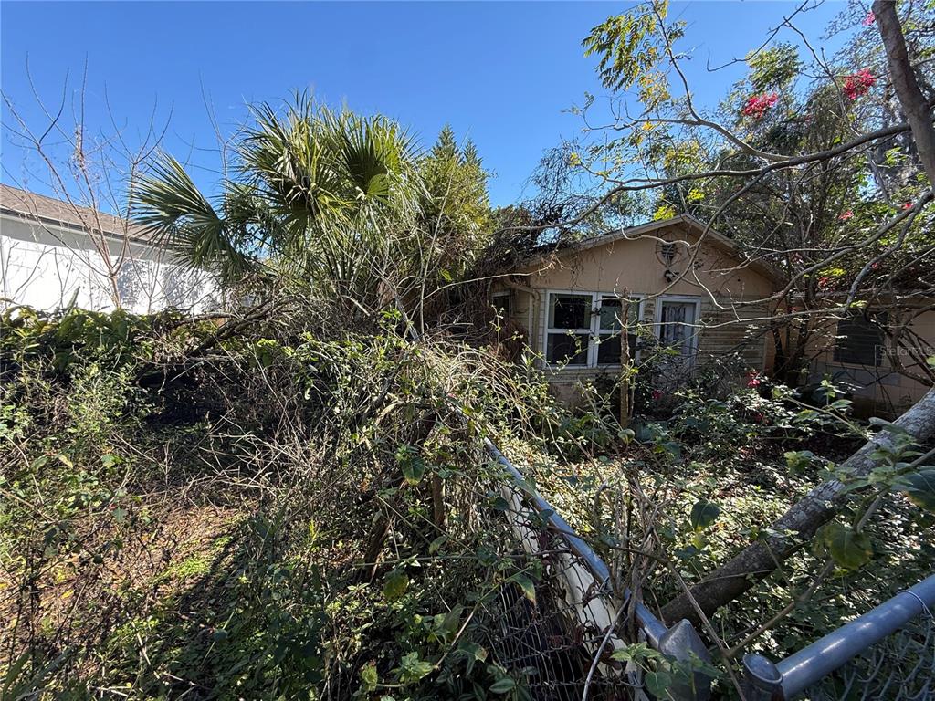 6515 Taylor Court New Port Richey, FL 34653 - Photo 10 of 23 a yellow house with lots of trees