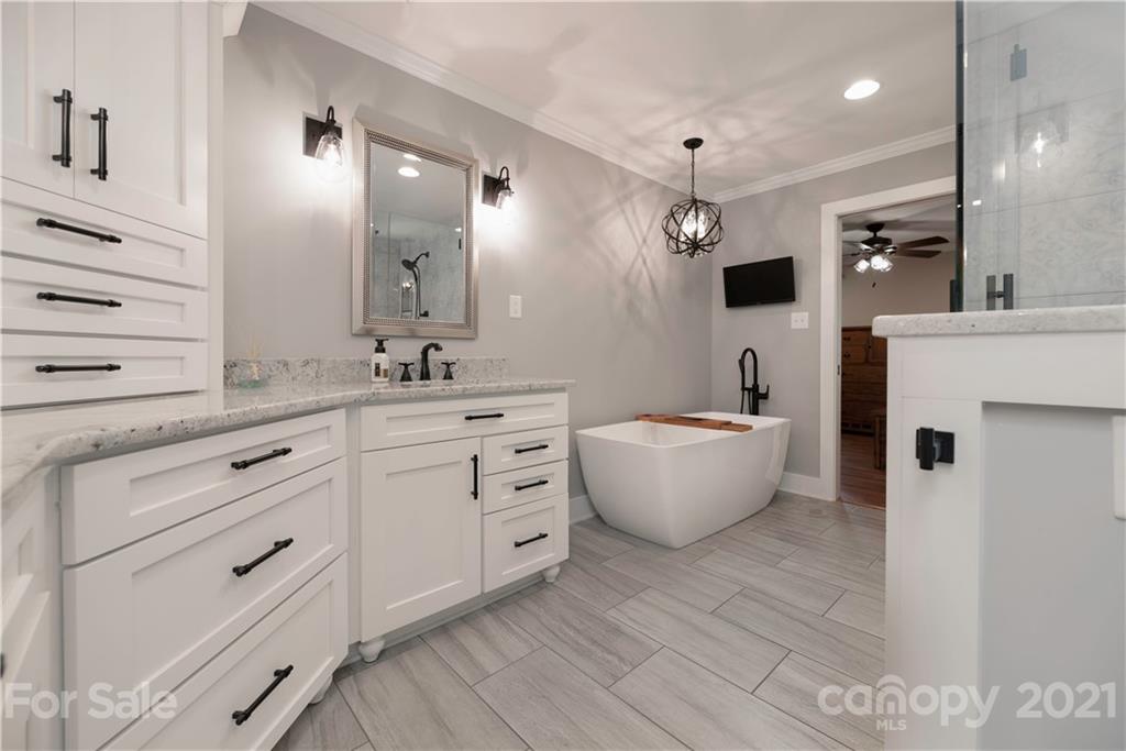 148 Lakeland Road Mooresville, NC 28117 - Photo 17 of 48 a bathroom with a double vanity sink mirror and bathtub