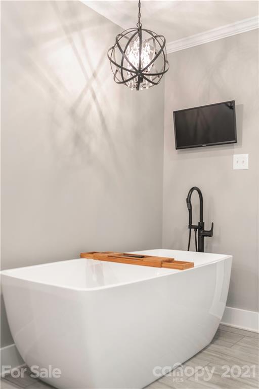 148 Lakeland Road Mooresville, NC 28117 - Photo 18 of 48 a white bath tub sitting in a bathroom