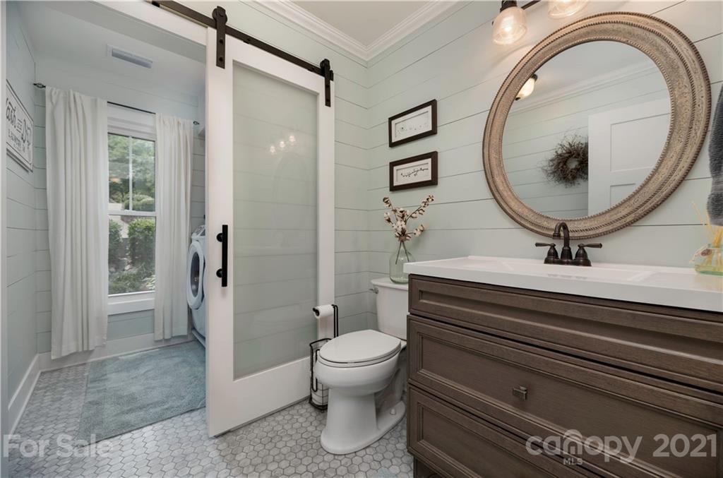 148 Lakeland Road Mooresville, NC 28117 - Photo 21 of 48 a bathroom with a toilet a sink and a mirror