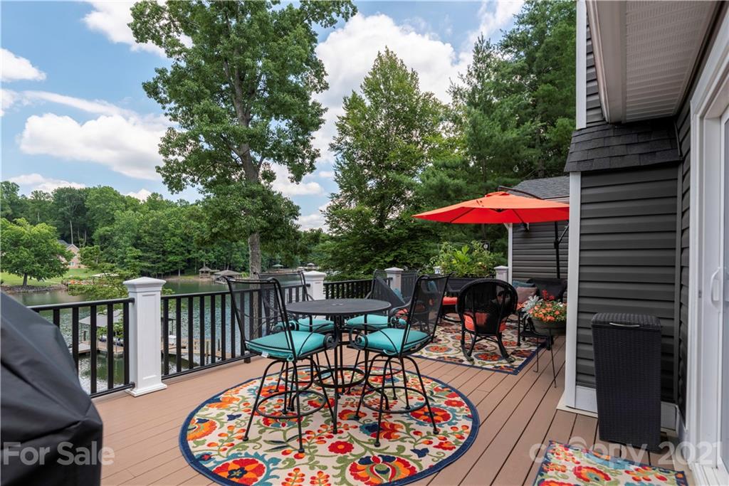 148 Lakeland Road Mooresville, NC 28117 - Photo 23 of 48 an outdoor sitting area with furniture and umbrella