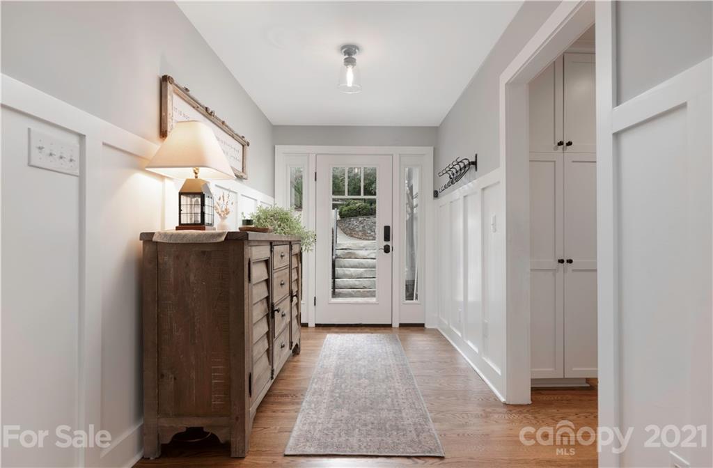 148 Lakeland Road Mooresville, NC 28117 - Photo 4 of 48 a view of a hallway with entryway wooden floor and cabinet