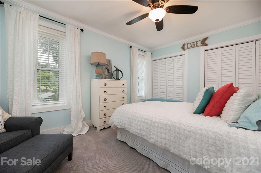148 Lakeland Road Mooresville, NC 28117 - Photo 32 of 48 a bedroom with a bed and wooden floor