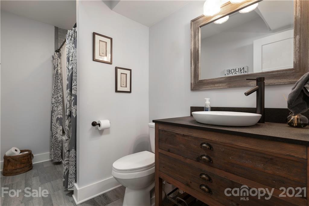 148 Lakeland Road Mooresville, NC 28117 - Photo 35 of 48 a bathroom with a toilet a sink and mirror