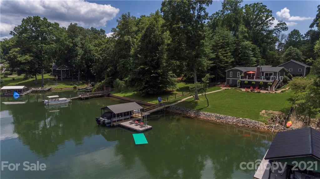 148 Lakeland Road Mooresville, NC 28117 - Photo 40 of 48 a view of a lake with wooden deck and outdoor space
