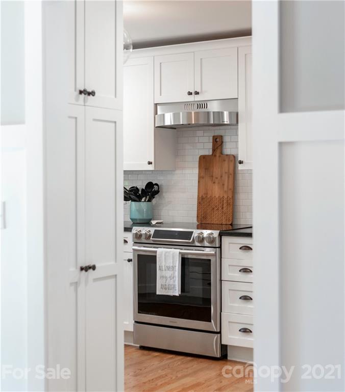 148 Lakeland Road Mooresville, NC 28117 - Photo 5 of 48 a kitchen with stainless steel appliances granite countertop white cabinets and a stove