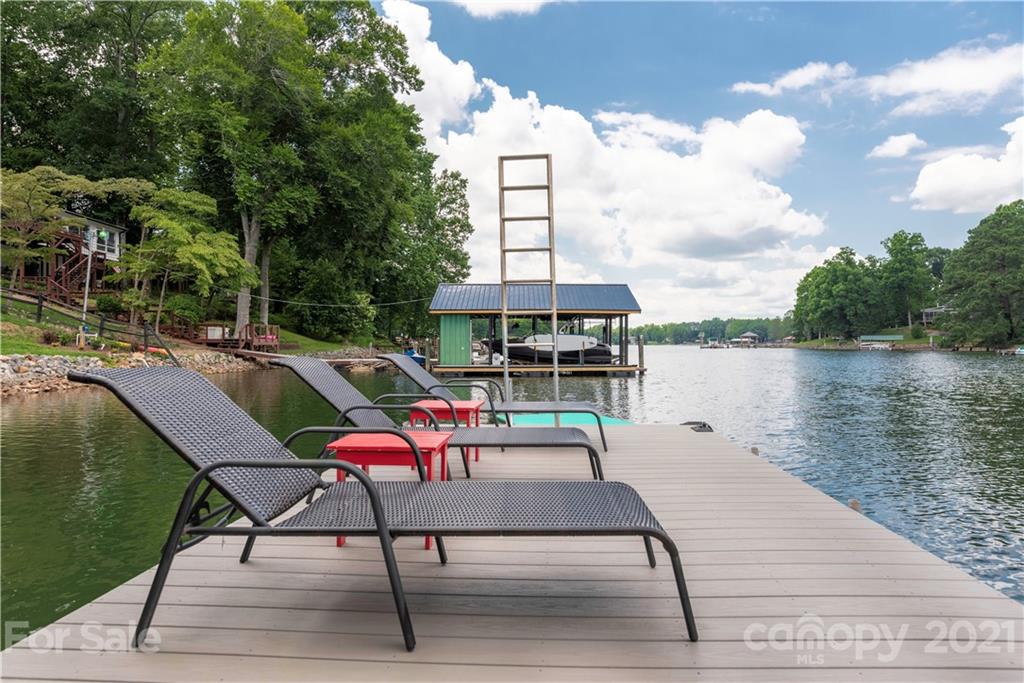 148 Lakeland Road Mooresville, NC 28117 - Photo 47 of 48 a roof deck with table and chairs a barbeque