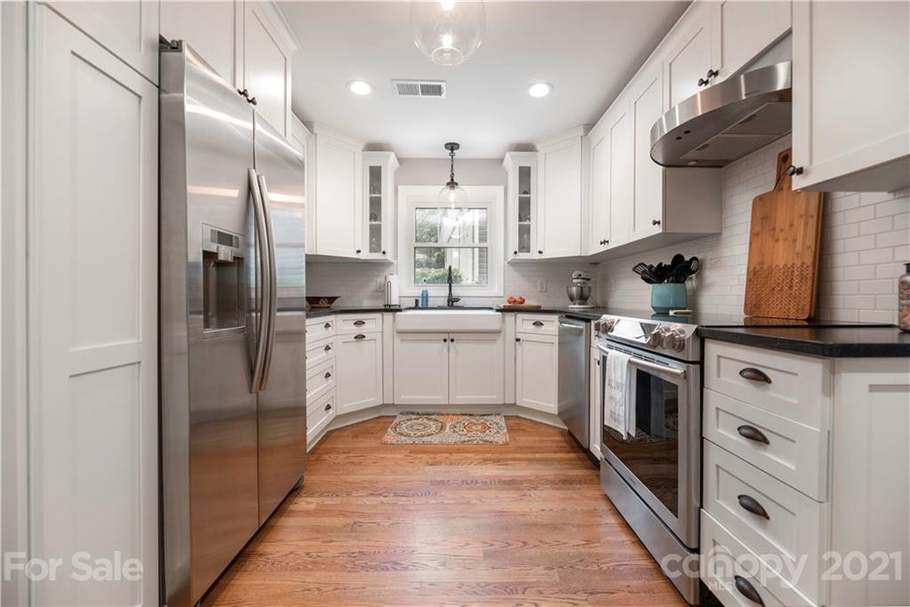 148 Lakeland Road Mooresville, NC 28117 - Photo 6 of 48 a kitchen with white cabinets stainless steel appliances and a window