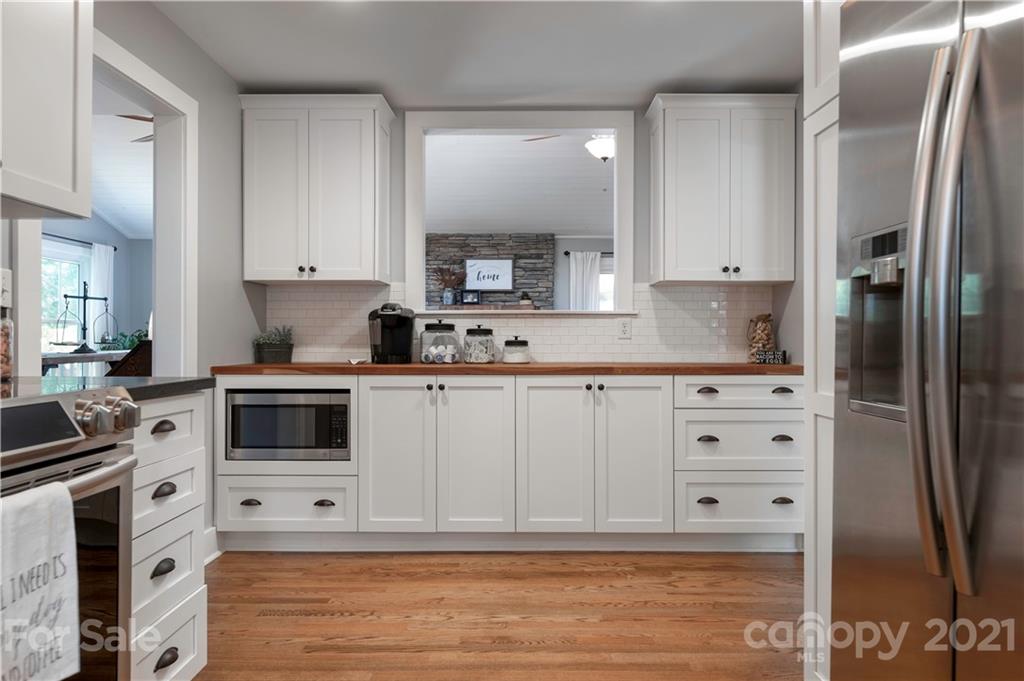148 Lakeland Road Mooresville, NC 28117 - Photo 7 of 48 a kitchen with stainless steel appliances a refrigerator sink and microwave