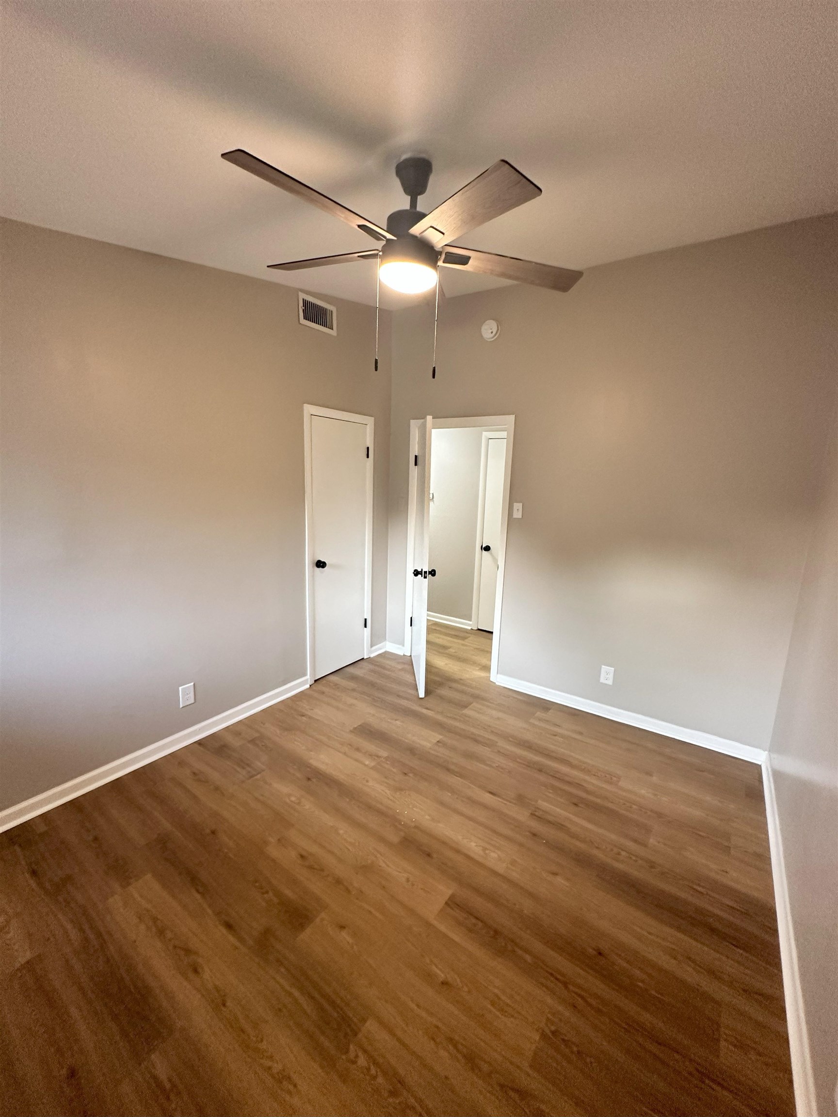 2820 Range Line Road Memphis, TN 38127 - Photo 12 of 35 wooden floor in an empty room with a window