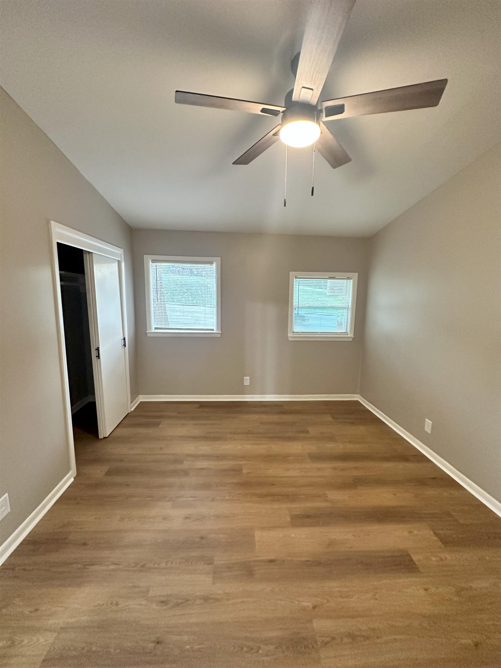 2820 Range Line Road Memphis, TN 38127 - Photo 13 of 35 a view of an empty room with window and wooden floor