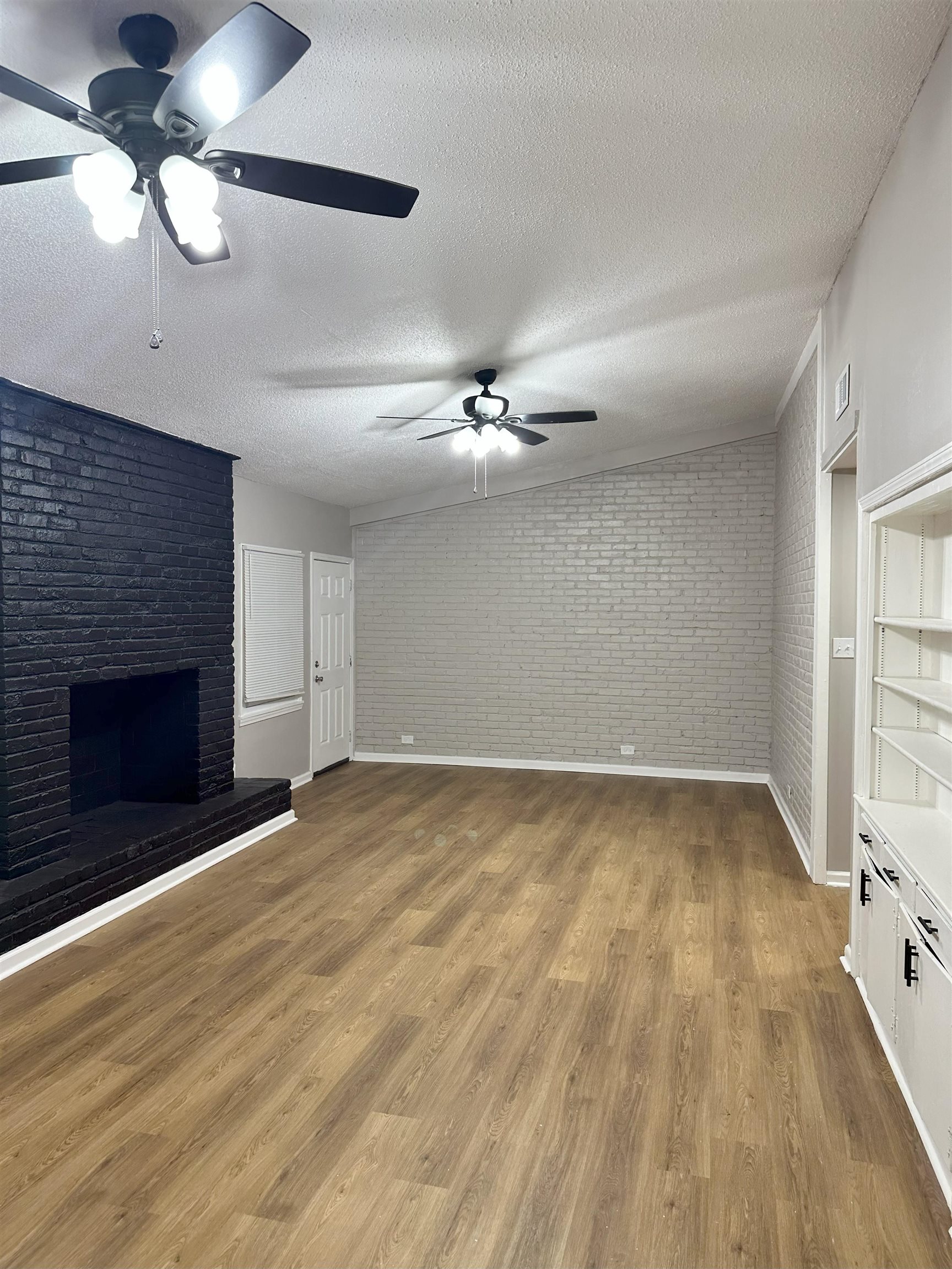 2820 Range Line Road Memphis, TN 38127 - Photo 15 of 35 a view of an empty room with a fireplace and a window