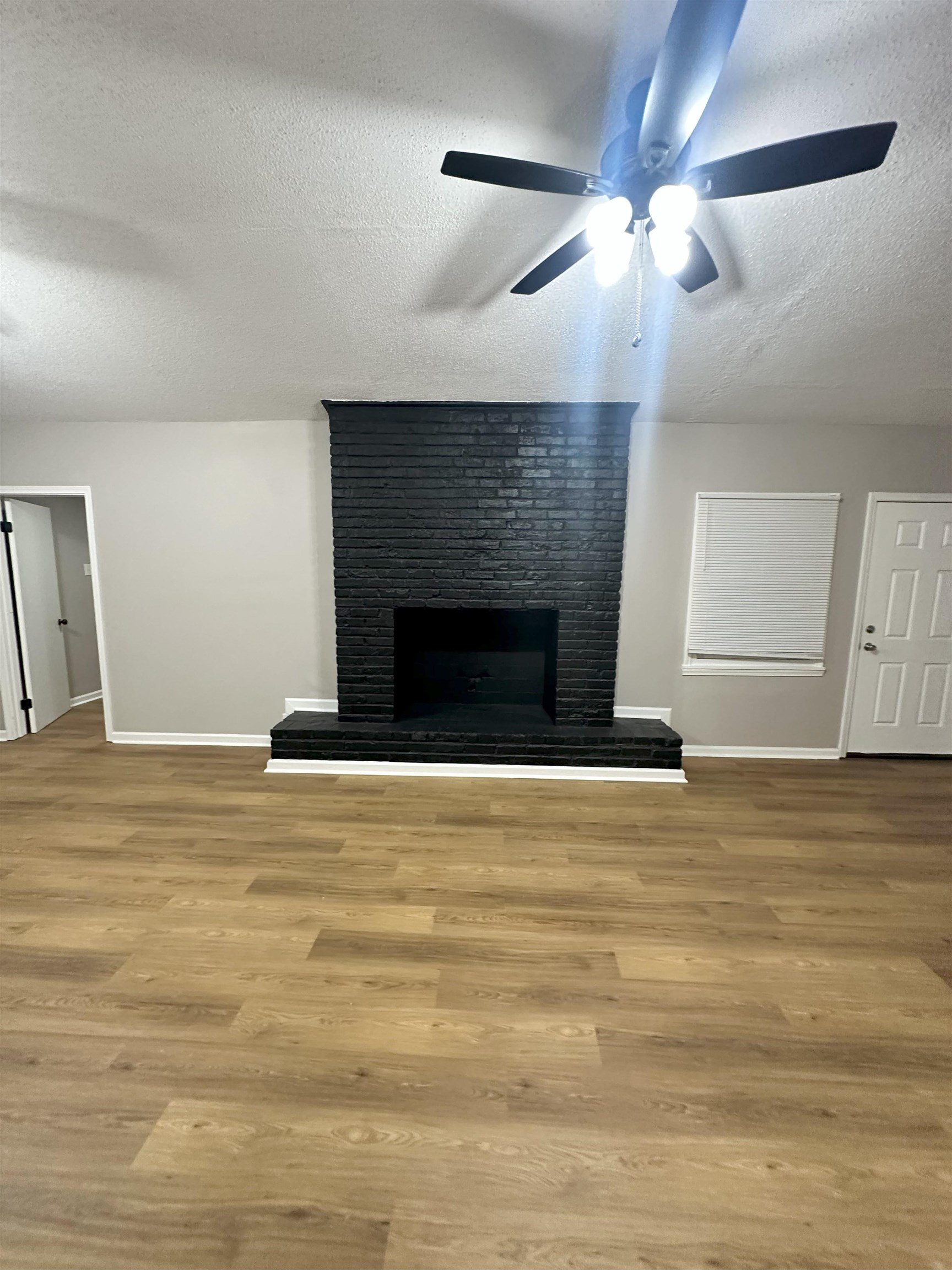 2820 Range Line Road Memphis, TN 38127 - Photo 18 of 35 a view of an empty room with wooden floor fireplace and a window