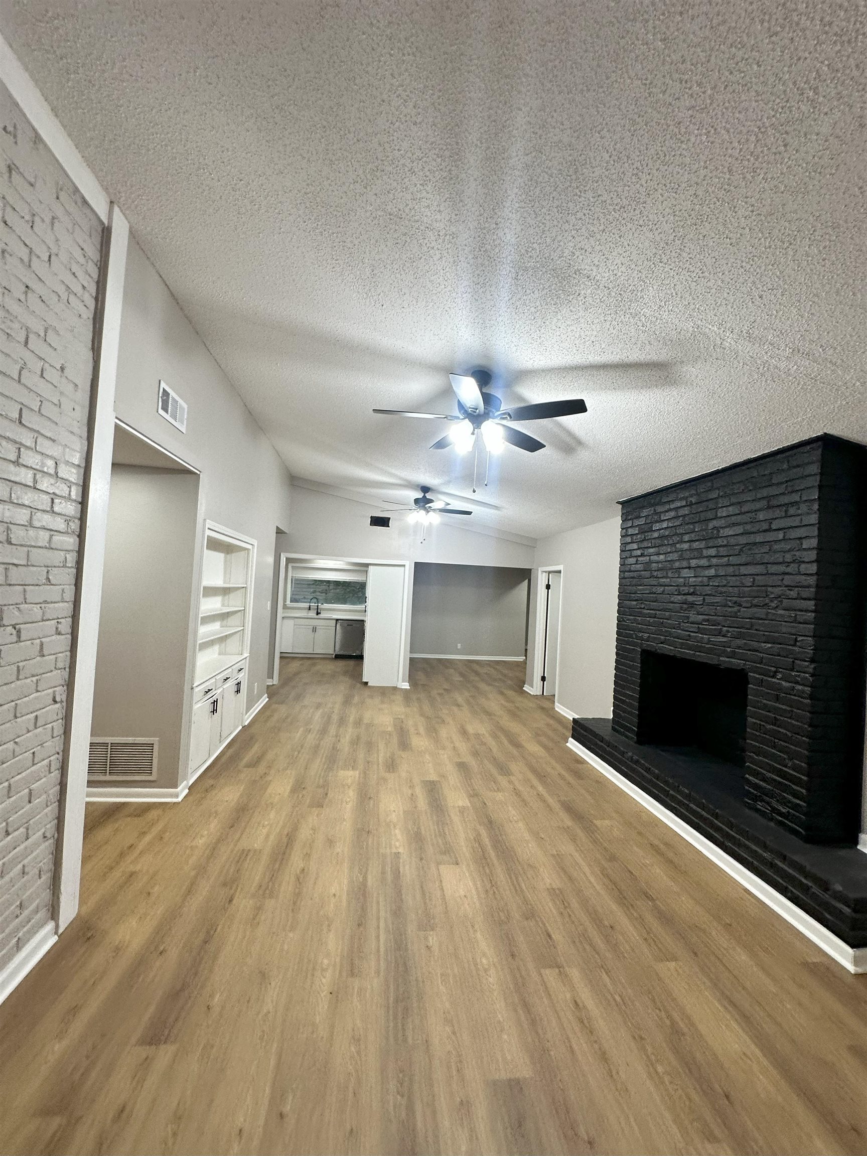 2820 Range Line Road Memphis, TN 38127 - Photo 19 of 35 a view of empty room with wooden floor and fireplace