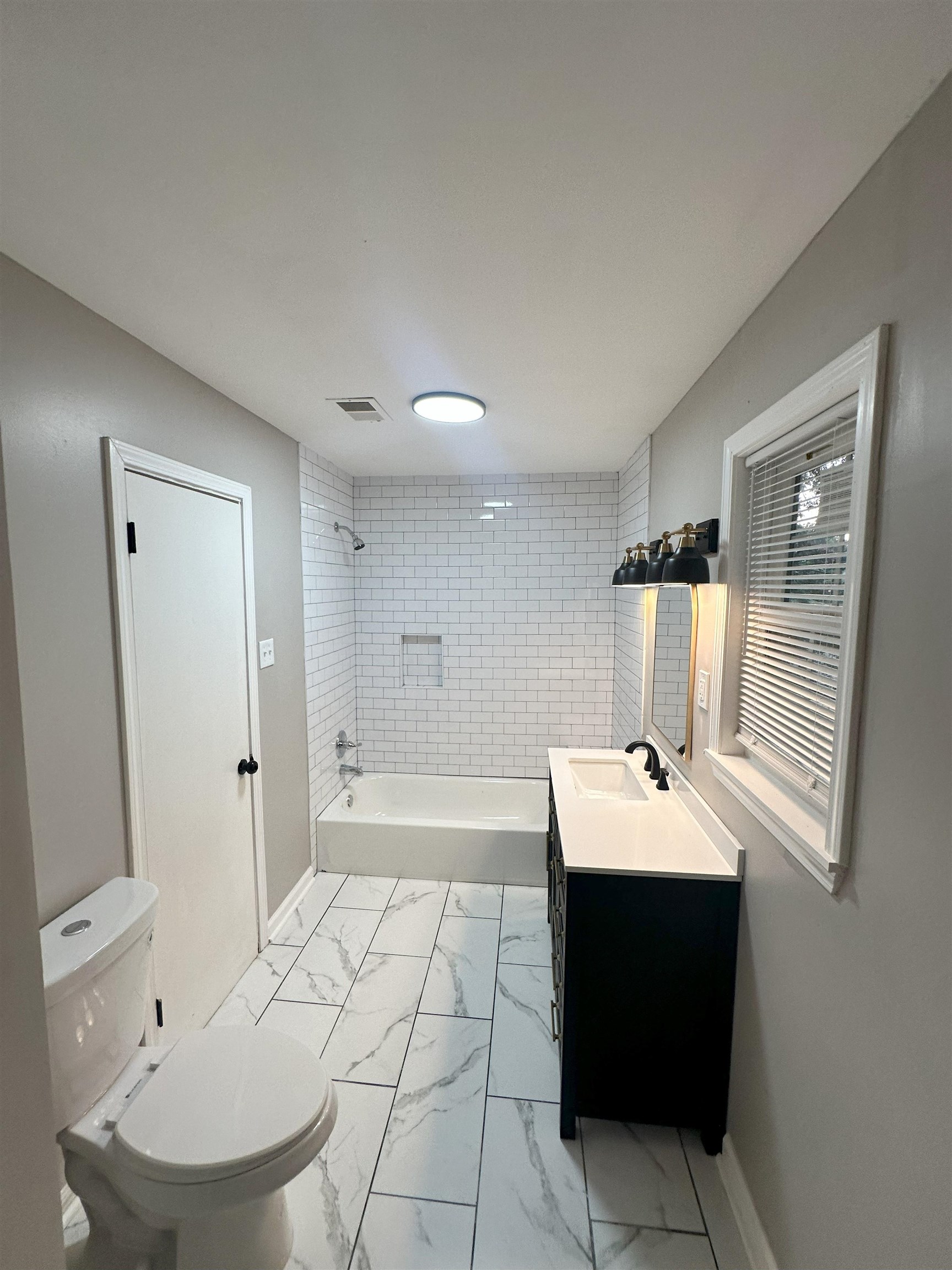 2820 Range Line Road Memphis, TN 38127 - Photo 23 of 35 a room with a sink a mirror and a lamp
