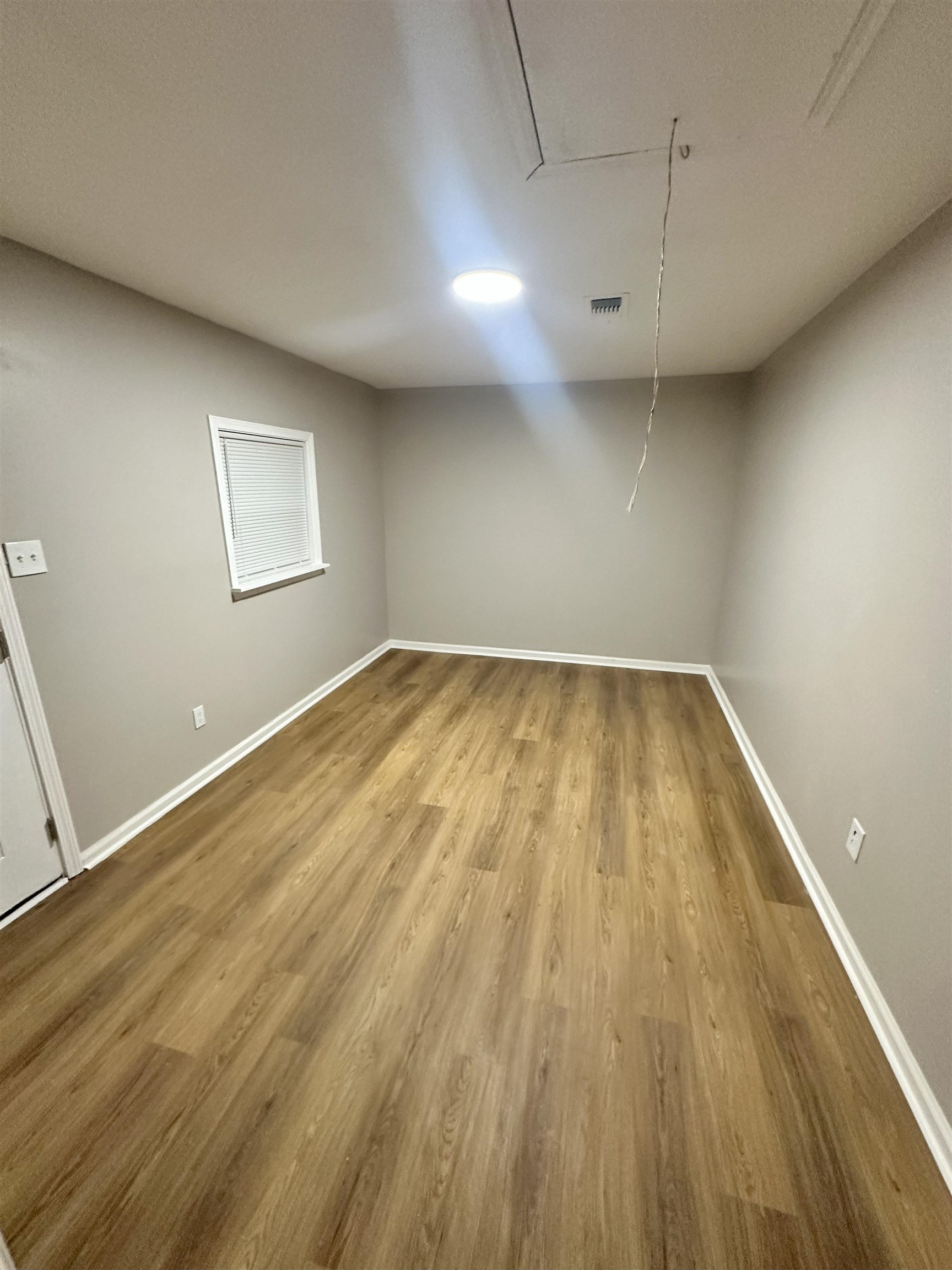 2820 Range Line Road Memphis, TN 38127 - Photo 29 of 35 an empty room with wooden floor and windows
