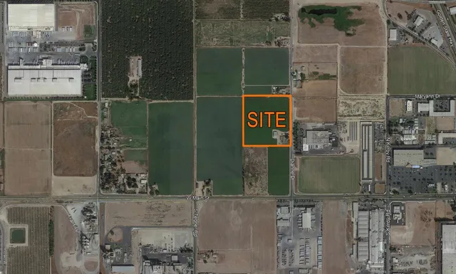 an aerial view of a house with a yard and mountain view in back