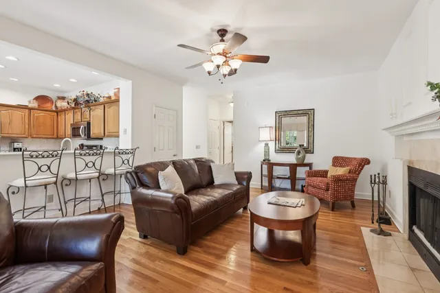 a living room with furniture a fireplace and a chandelier