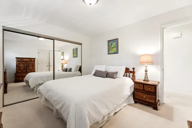 a bedroom with a bed and a lamp