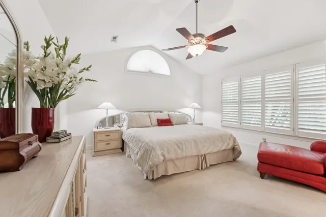 a bedroom with bed and a chandelier