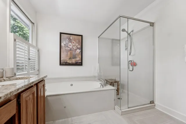 a bathroom with a bathtub and a shower