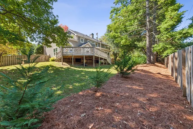 a view of a house with backyard and sitting area