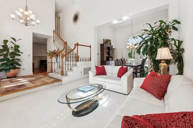 a living room with furniture and a chandelier