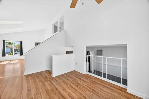 a view of a hallway with wooden floor and entryway