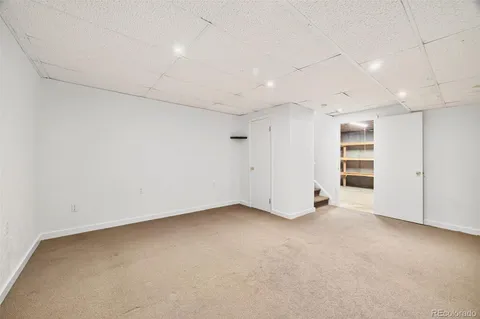 an empty room with a empty space and windows