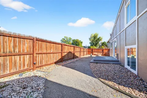 a view of a backyard with wooden fence