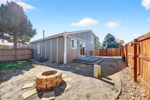 a view of a backyard with wooden fence