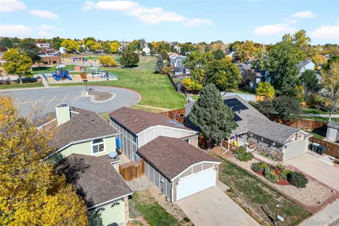 an aerial view of multiple houses with yard