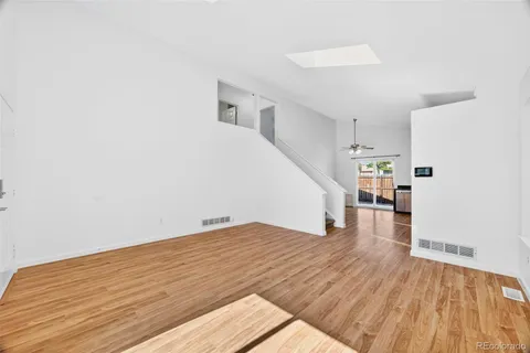 a view of empty room with wooden floor