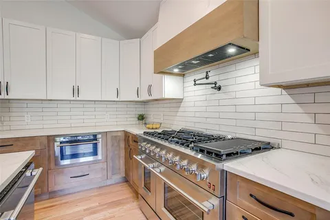 a living room with a bed furniture and a fireplace